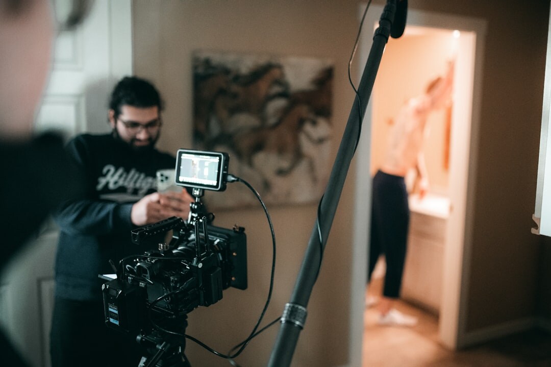 Documentary film crew filming an interview with a camera and boom microphone